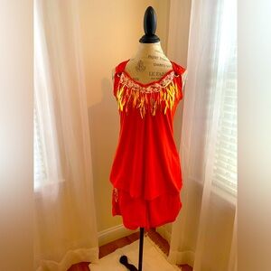 Orange top and shorts with sparkly tassels